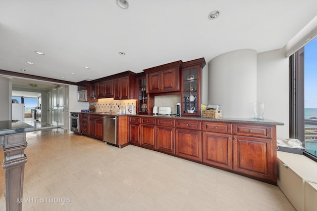 505 N Lake Shore Dr Unit 2110-11, Chicago, IL 60611 - kitchen featuring stainless steel appliances, glass insert cabinets, tasteful backsplash, dark brown cabinets, and dark countertops