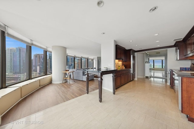 505 N Lake Shore Dr Unit 2110-11, Chicago, IL 60611 - kitchen with dark countertops, open floor plan, stainless steel microwave, and recessed lighting