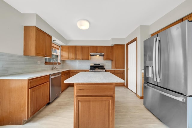 15 Harrison Ln, Streamwood, IL 60107 - kitchen featuring stainless steel appliances, under cabinet range hood, light countertops, decorative backsplash, and a center island
