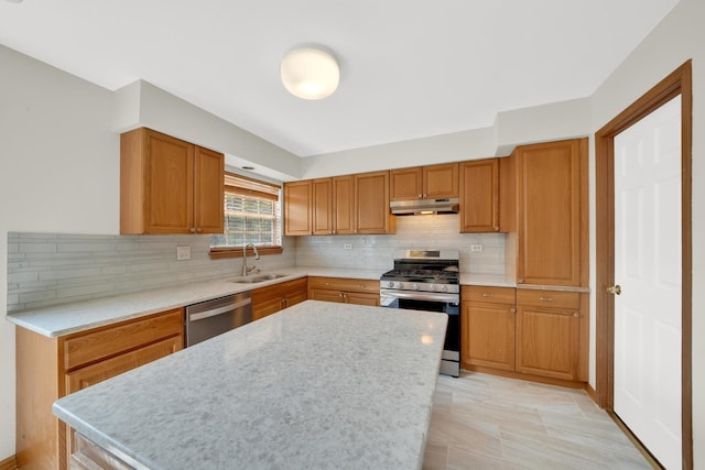 15 Harrison Ln, Streamwood, IL 60107 - kitchen featuring appliances with stainless steel finishes, under cabinet range hood, decorative backsplash, and a center island