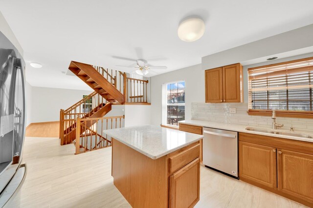 15 Harrison Ln, Streamwood, IL 60107 - kitchen with stainless steel dishwasher, tasteful backsplash, a kitchen island, ceiling fan, and brown cabinets