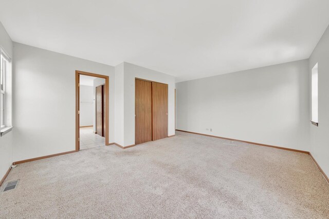 15 Harrison Ln, Streamwood, IL 60107 - unfurnished bedroom with light colored carpet and a closet