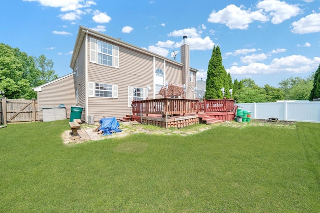 15 Harrison Ln, Streamwood, IL 60107 - rear view of house with a deck, a fenced backyard, and a chimney