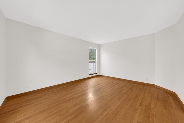 15 Harrison Ln, Streamwood, IL 60107 - spare room featuring light wood-style floors and baseboards