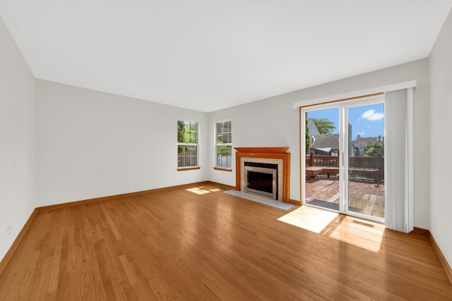 15 Harrison Ln, Streamwood, IL 60107 - unfurnished living room featuring wood finished floors and a tiled fireplace