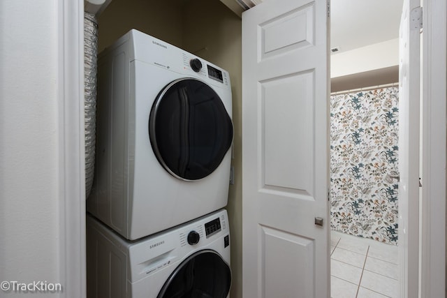 7515 Nantucket Dr Unit 202, Darien, IL 60561 - washroom featuring stacked washing machine and dryer and tile patterned flooring