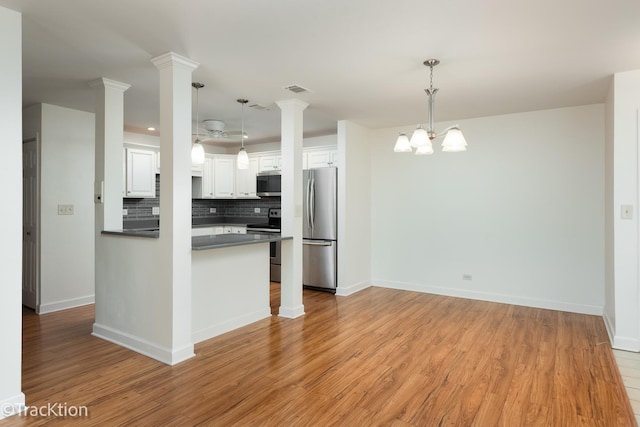 7515 Nantucket Dr Unit 202, Darien, IL 60561 - kitchen with stainless steel appliances, dark countertops, backsplash, and light wood-style floors