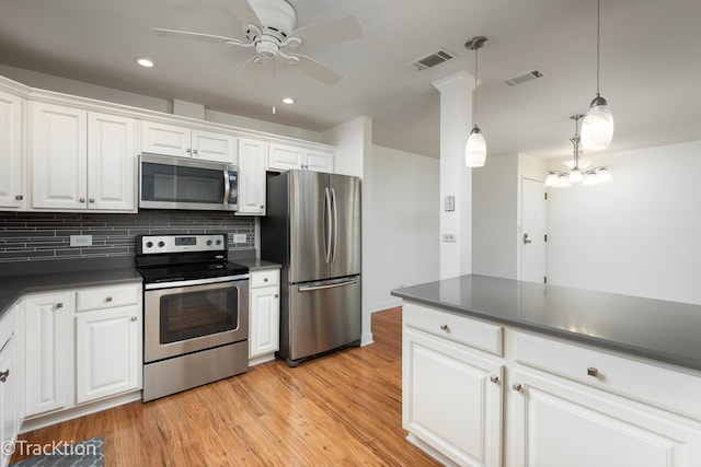 7515 Nantucket Dr Unit 202, Darien, IL 60561 - kitchen with appliances with stainless steel finishes, dark countertops, white cabinets, light wood-type flooring, and recessed lighting