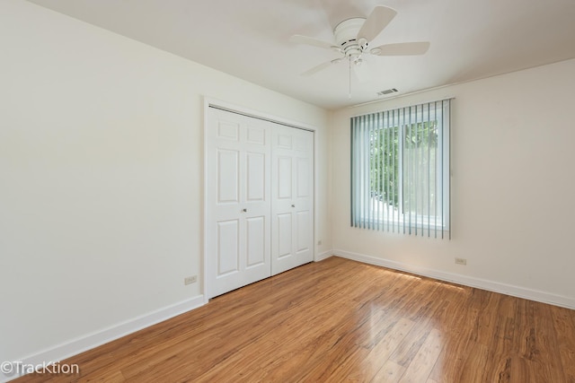 7515 Nantucket Dr Unit 202, Darien, IL 60561 - unfurnished bedroom with light wood finished floors, a closet, and a ceiling fan