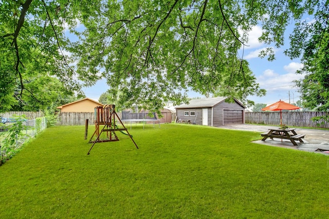 7912 S 85th Ave, Justice, IL 60458 - fenced backyard featuring a trampoline, an outbuilding, and a garage