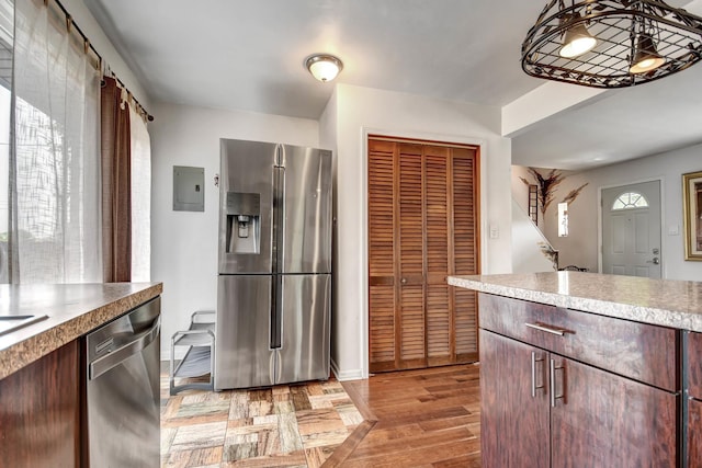 7912 S 85th Ave, Justice, IL 60458 - kitchen with appliances with stainless steel finishes, light wood-type flooring, electric panel, and light countertops