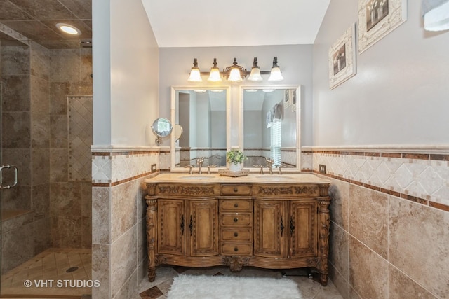 2578 Crestview Dr, Aurora, IL 60502 - bathroom featuring tile walls, a stall shower, double vanity, and wainscoting