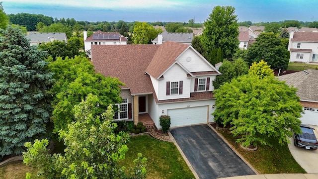 2578 Crestview Dr, Aurora, IL 60502 - view of front of property with asphalt driveway, an attached garage, a residential view, and roof with shingles