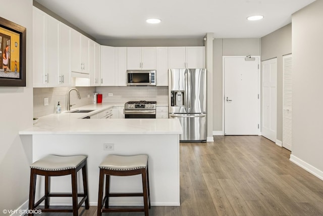 1101 S State St Unit 2202, Chicago, IL 60605 - kitchen featuring stainless steel appliances, light countertops, a peninsula, backsplash, and recessed lighting