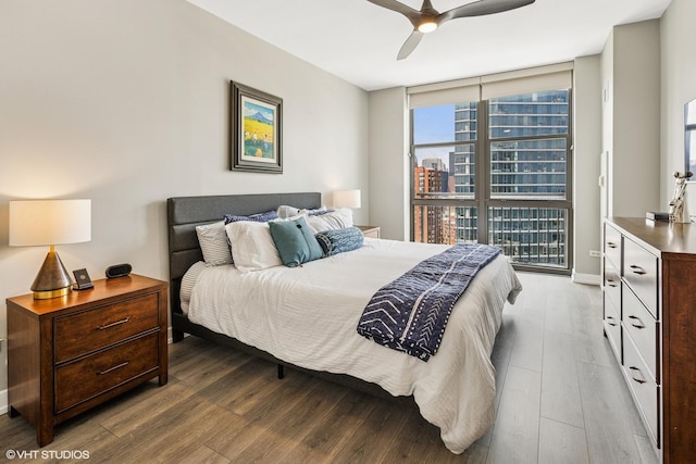 1101 S State St Unit 2202, Chicago, IL 60605 - bedroom featuring wood finished floors, a wall of windows, a ceiling fan, and a city view