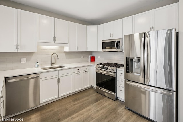 1101 S State St Unit 2202, Chicago, IL 60605 - kitchen with appliances with stainless steel finishes, light countertops, white cabinets, wood finished floors, and tasteful backsplash