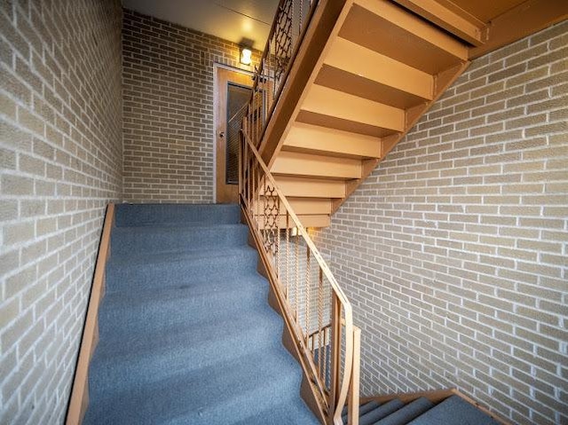 10109 S Cicero Ave Unit 302, Oak Lawn, IL 60453 - staircase with brick wall
