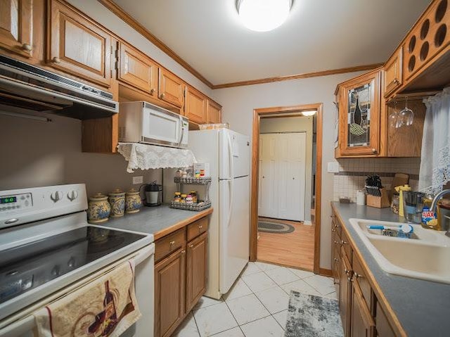 10109 S Cicero Ave Unit 302, Oak Lawn, IL 60453 - kitchen featuring white appliances, extractor fan, brown cabinetry, ornamental molding, and decorative backsplash