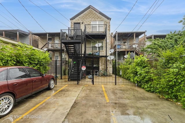 3115 W Lexington St, Chicago, IL 60612 - view of front of property featuring uncovered parking, a gate, stairway, and stone siding