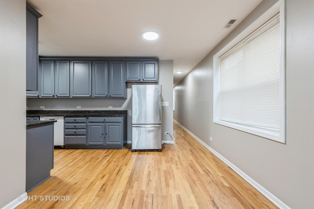 3115 W Lexington St, Chicago, IL 60612 - kitchen featuring freestanding refrigerator, dishwasher, dark countertops, and light wood-style flooring