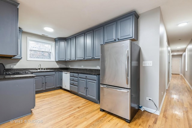 3115 W Lexington St, Chicago, IL 60612 - kitchen with freestanding refrigerator, light wood-type flooring, recessed lighting, dark stone countertops, and white dishwasher