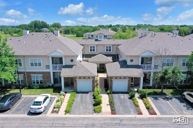 614 Pineridge Dr N Unit 614, Oswego, IL 60543 - view of front of house with brick siding, a balcony, a residential view, and uncovered parking
