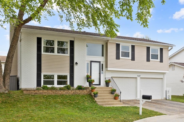 1669 W Bayside Ct, Hoffman Estates, IL 60192 - raised ranch featuring a front lawn, an attached garage, a chimney, driveway, and brick siding