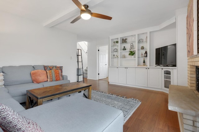 1669 W Bayside Ct, Hoffman Estates, IL 60192 - living area featuring wood finished floors, a ceiling fan, a brick fireplace, beamed ceiling, and stairway