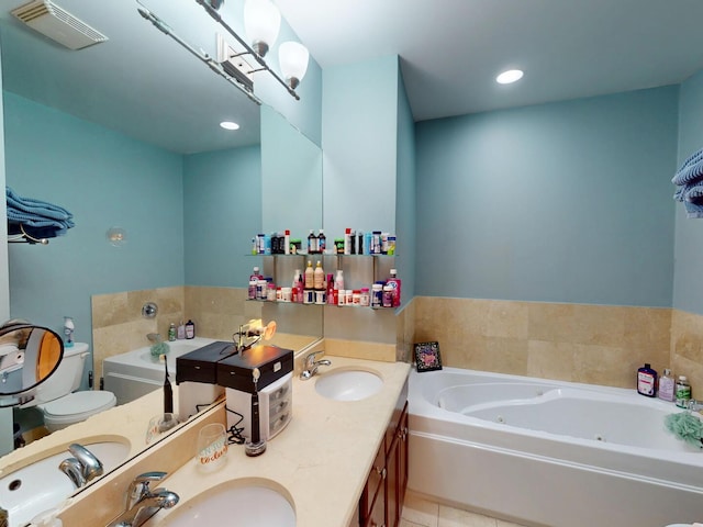 4968 N Milwaukee Ave Unit 2W, Chicago, IL 60630 - bathroom featuring a jetted tub, double vanity, tile patterned floors, and recessed lighting