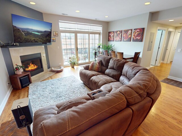 4968 N Milwaukee Ave Unit 2W, Chicago, IL 60630 - living area featuring a tile fireplace, wood finished floors, and recessed lighting