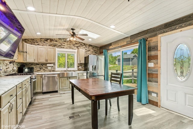 30 Aspen Ln, Wilmington, IL 60481 - kitchen featuring stainless steel appliances, a skylight, lofted ceiling, a ceiling fan, and light wood finished floors