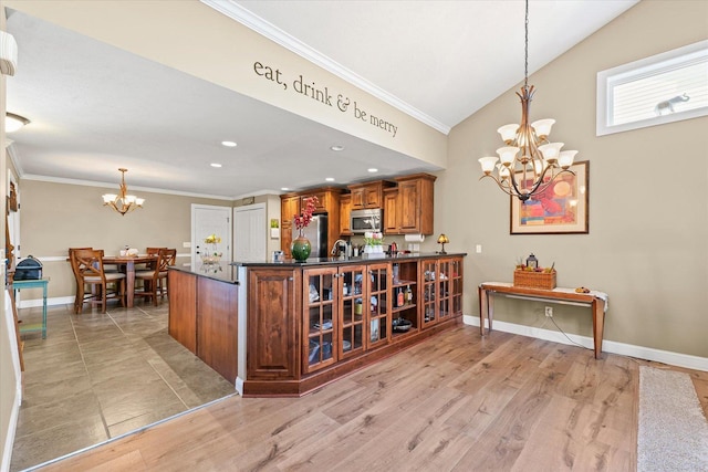 4537 Nicklaus Dr, Champaign, IL 61822 - kitchen with a chandelier, appliances with stainless steel finishes, brown cabinets, ornamental molding, and glass insert cabinets