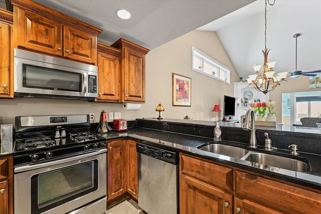 4537 Nicklaus Dr, Champaign, IL 61822 - kitchen featuring stainless steel appliances, dark stone counters, a chandelier, brown cabinets, and vaulted ceiling