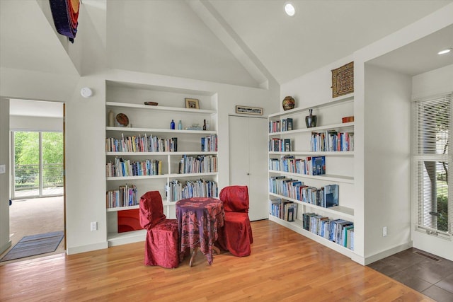 2405 Prairieridge Pl, Champaign, IL 61822 - living area with wood finished floors, built in shelves, vaulted ceiling, and recessed lighting