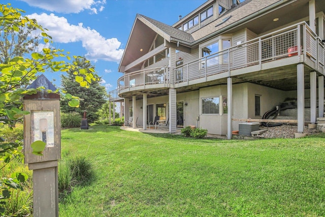 2405 Prairieridge Pl, Champaign, IL 61822 - back of property featuring a lawn, a patio, a shingled roof, and a balcony