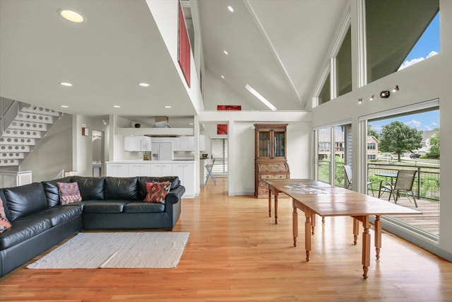 2405 Prairieridge Pl, Champaign, IL 61822 - living area with stairs, light wood-type flooring, recessed lighting, and a towering ceiling
