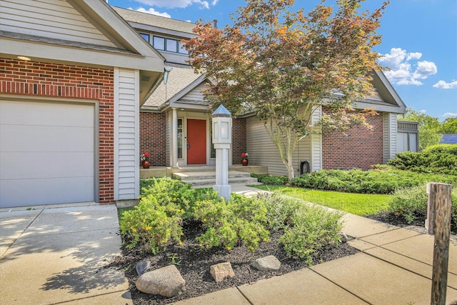 2405 Prairieridge Pl, Champaign, IL 61822 - property entrance with brick siding, a garage, and a shingled roof