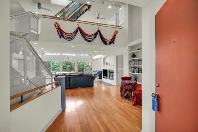 2405 Prairieridge Pl, Champaign, IL 61822 - hallway with a towering ceiling, wood finished floors, built in features, and stairs