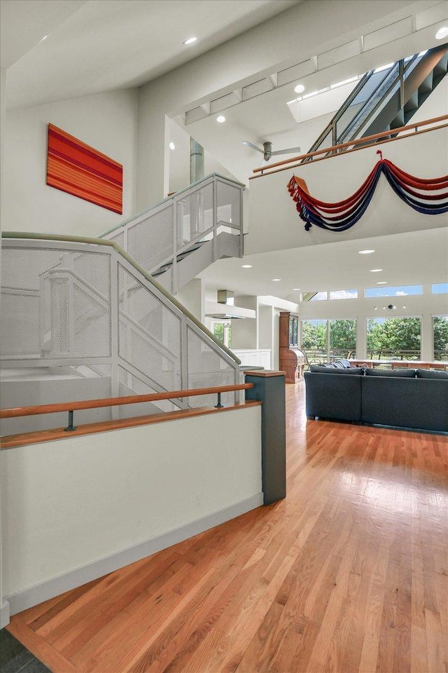 2405 Prairieridge Pl, Champaign, IL 61822 - stairs with a skylight, wood finished floors, a high ceiling, and recessed lighting