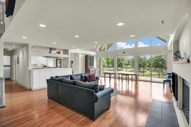 2405 Prairieridge Pl, Champaign, IL 61822 - living room featuring light wood-type flooring, a glass covered fireplace, recessed lighting, and a high ceiling