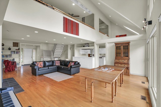 2405 Prairieridge Pl, Champaign, IL 61822 - living room featuring light wood finished floors, stairway, recessed lighting, and a high ceiling