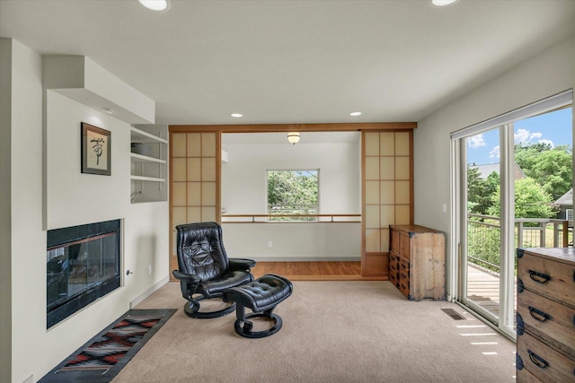 2405 Prairieridge Pl, Champaign, IL 61822 - unfurnished room with plenty of natural light, a glass covered fireplace, carpet, and recessed lighting
