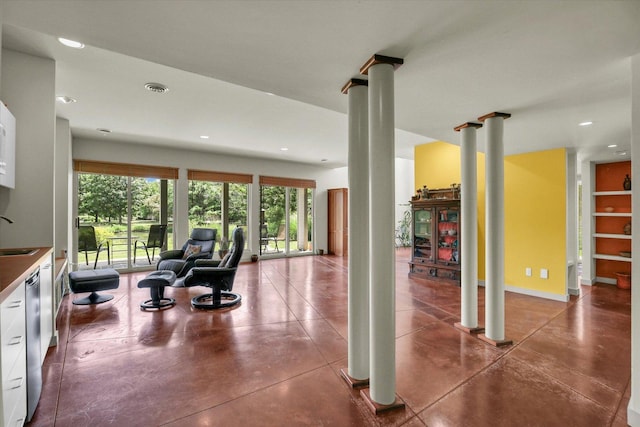 2405 Prairieridge Pl, Champaign, IL 61822 - living room featuring decorative columns, recessed lighting, and concrete flooring