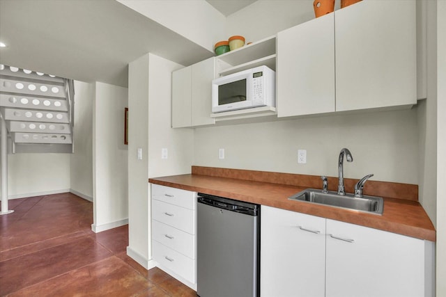 2405 Prairieridge Pl, Champaign, IL 61822 - kitchen with stainless steel dishwasher, white microwave, finished concrete flooring, white cabinets, and open shelves