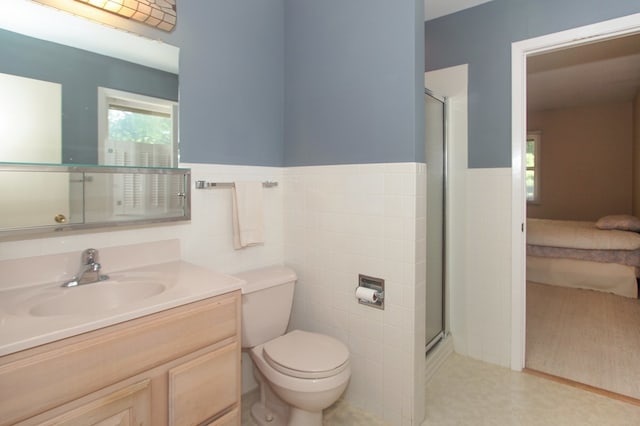 2114 Country Knoll Ln, Elgin, IL 60123 - bathroom with vanity, tile walls, a stall shower, and a wainscoted wall