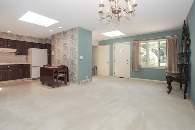2114 Country Knoll Ln, Elgin, IL 60123 - living room with a skylight, a chandelier, and light colored carpet