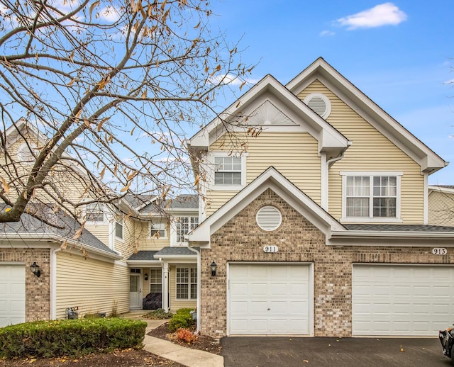 911 Sheridan Cir, Naperville, IL 60563 - view of front facade with driveway, brick siding, and a garage