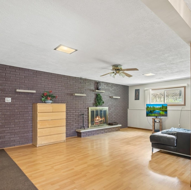 500 S Princeton Ave, Itasca, IL 60143 - living area featuring a textured ceiling, a ceiling fan, wood finished floors, a brick fireplace, and brick wall