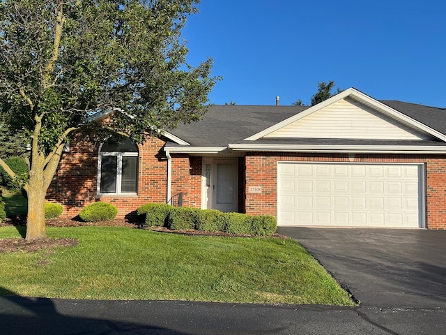 27108 S Fountainview Dr, Crete, IL 60417 - view of front of property featuring a front lawn, brick siding, asphalt driveway, and an attached garage