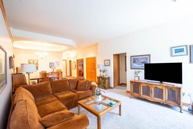 9000 226th Ct Unit 23B, Salem, WI 53168 - living room with a chandelier, carpet flooring, and a raised ceiling